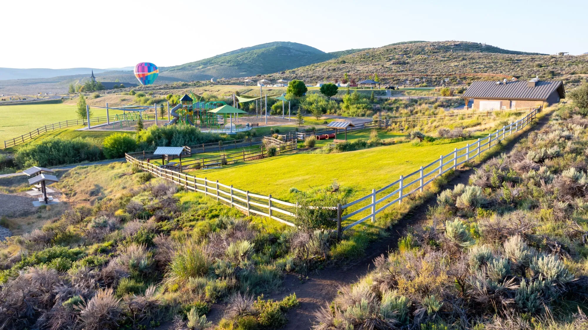 Trailside Park's Dog Park with the Trailside Bike Park and playground in the distance.