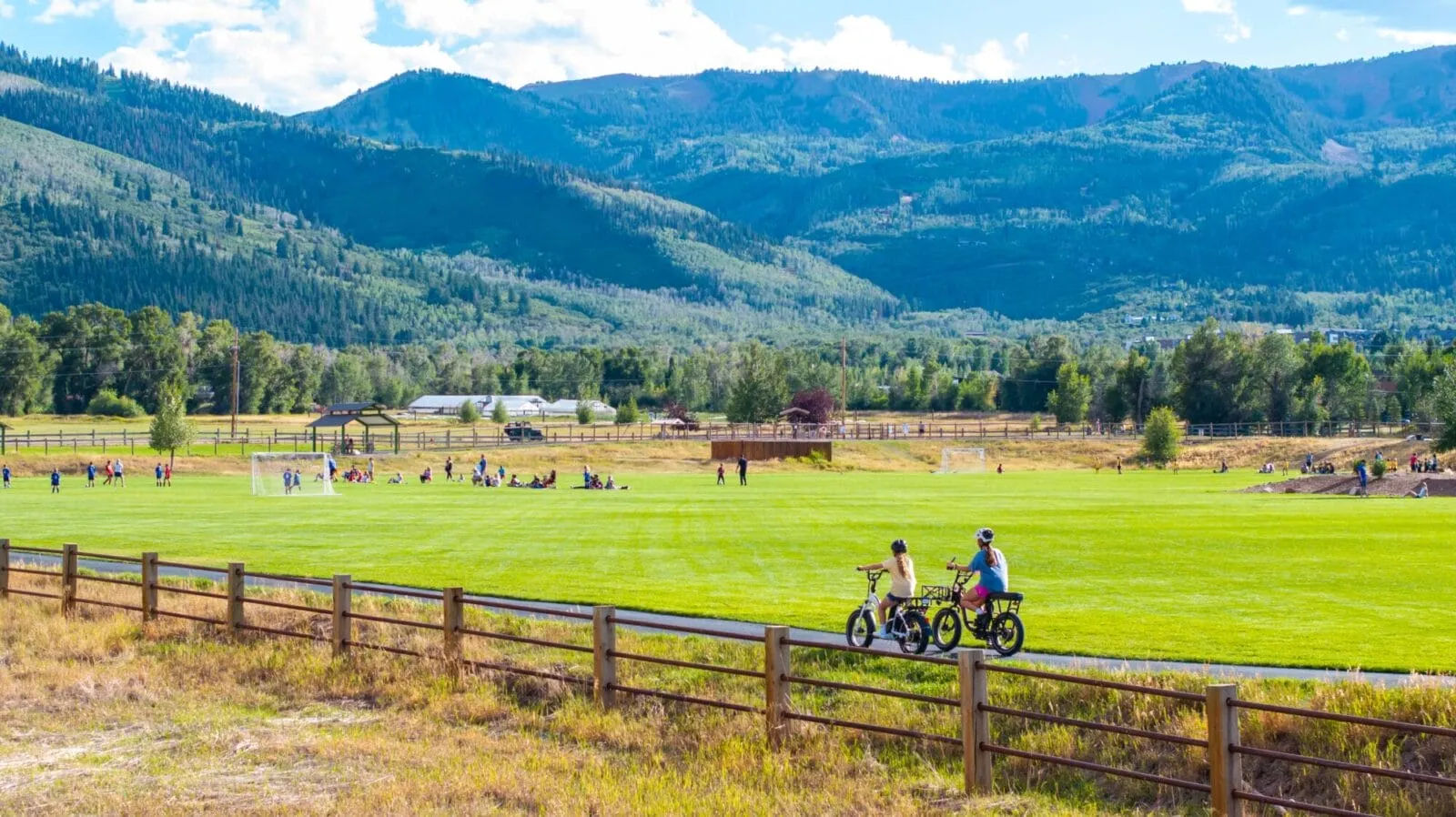 Drone footage of Willow Creek Park's paved commuter pathway with the Park City Mountains