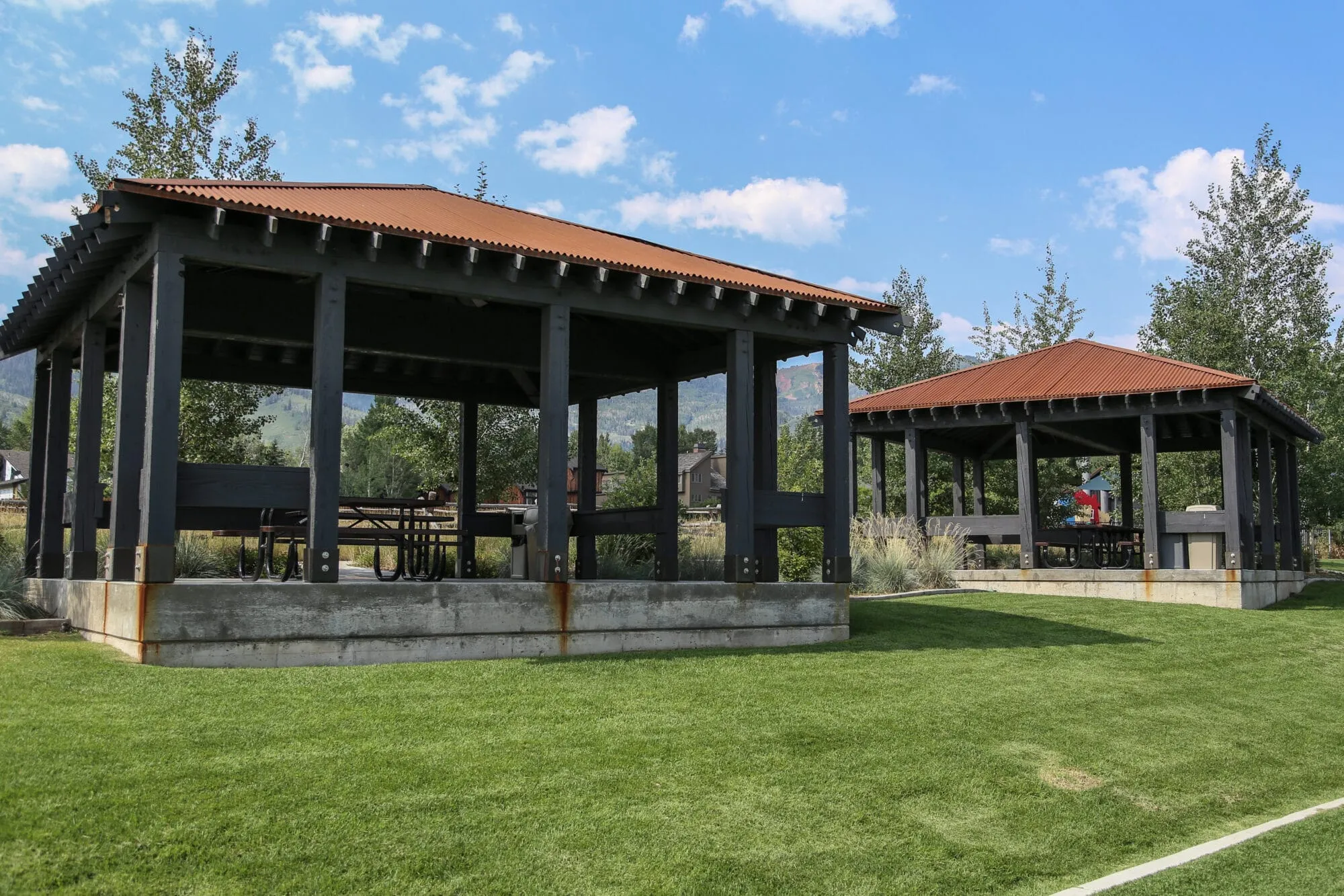 Two pavilions next to a turf field that are available for rent at Matt Knoop Memorial Park.