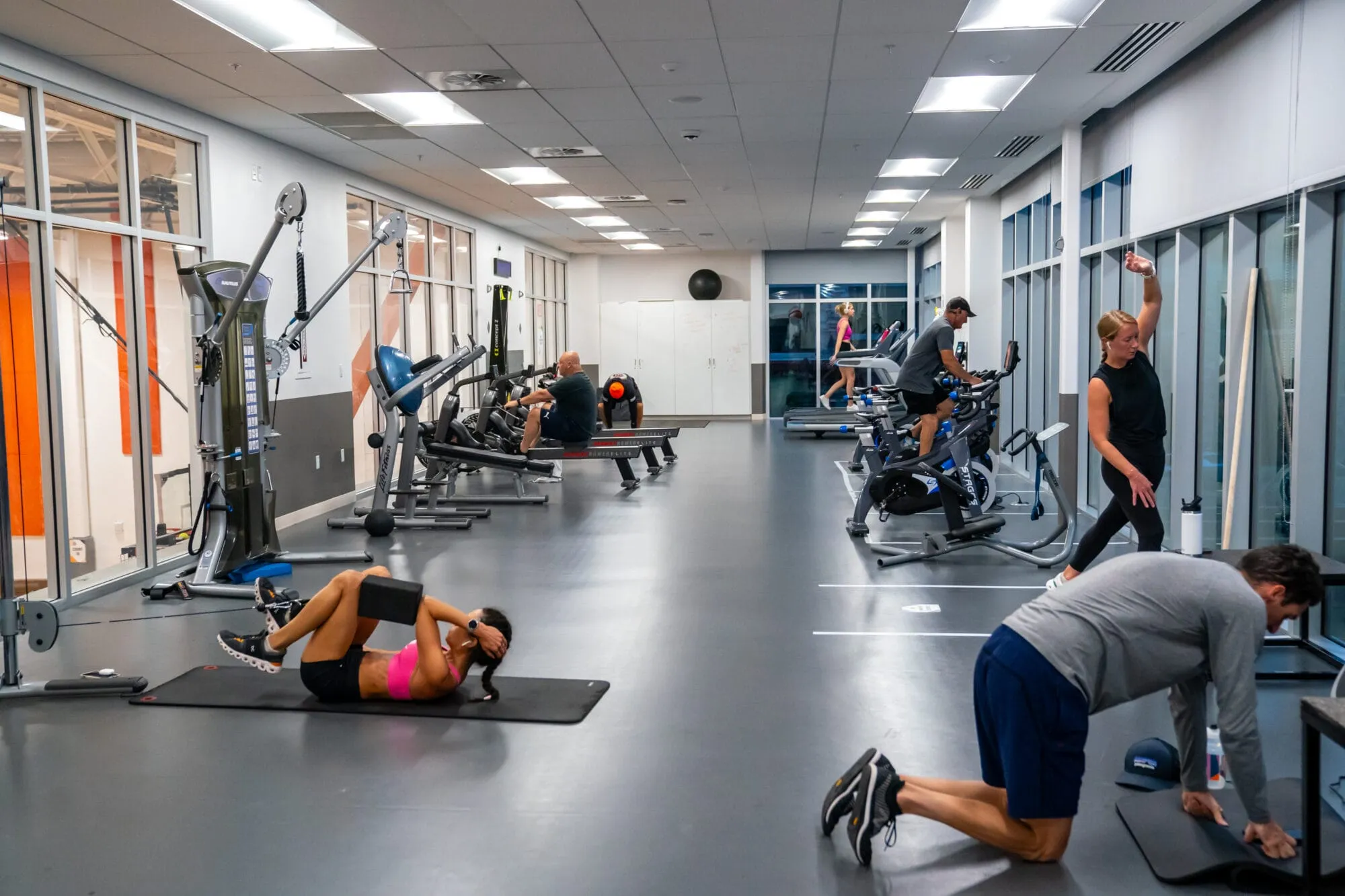 Patrons at the Basin Recreation Fieldhouse work out using fitness equipment.