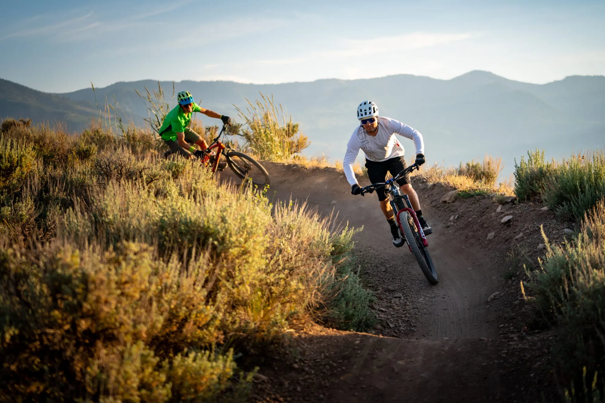 Two mountain bikers riding around a turn on the Trailside Bike Park.